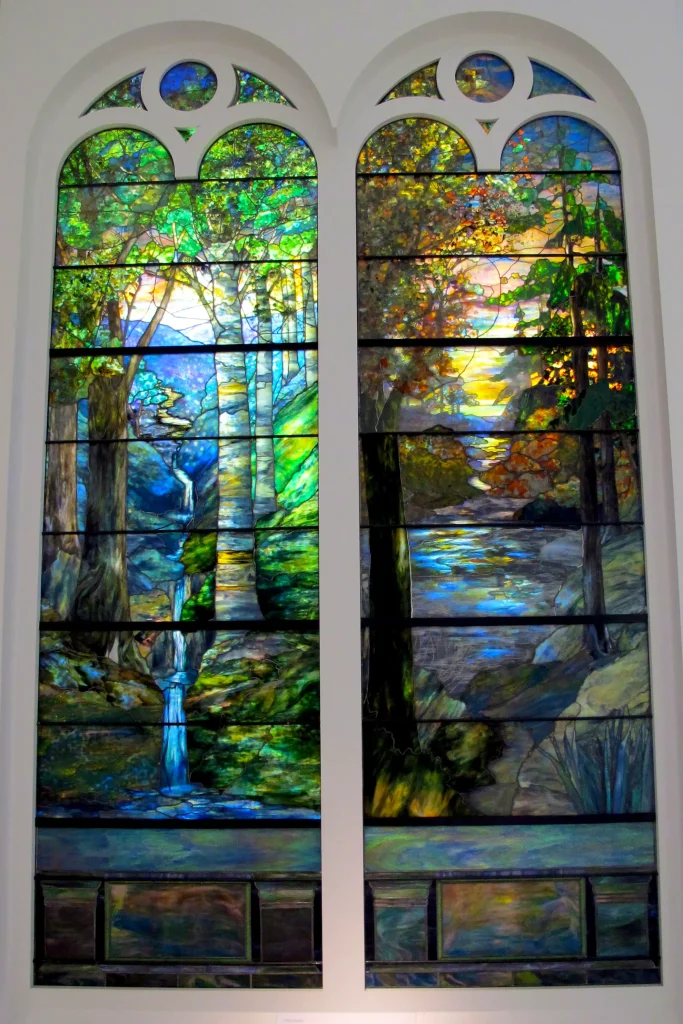 Windows with sunrise in the forest at springtime, and autumn sunset by Louis Comfort Tiffany
